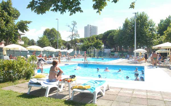 Swimming pools equipped with sun beds and umbrellas